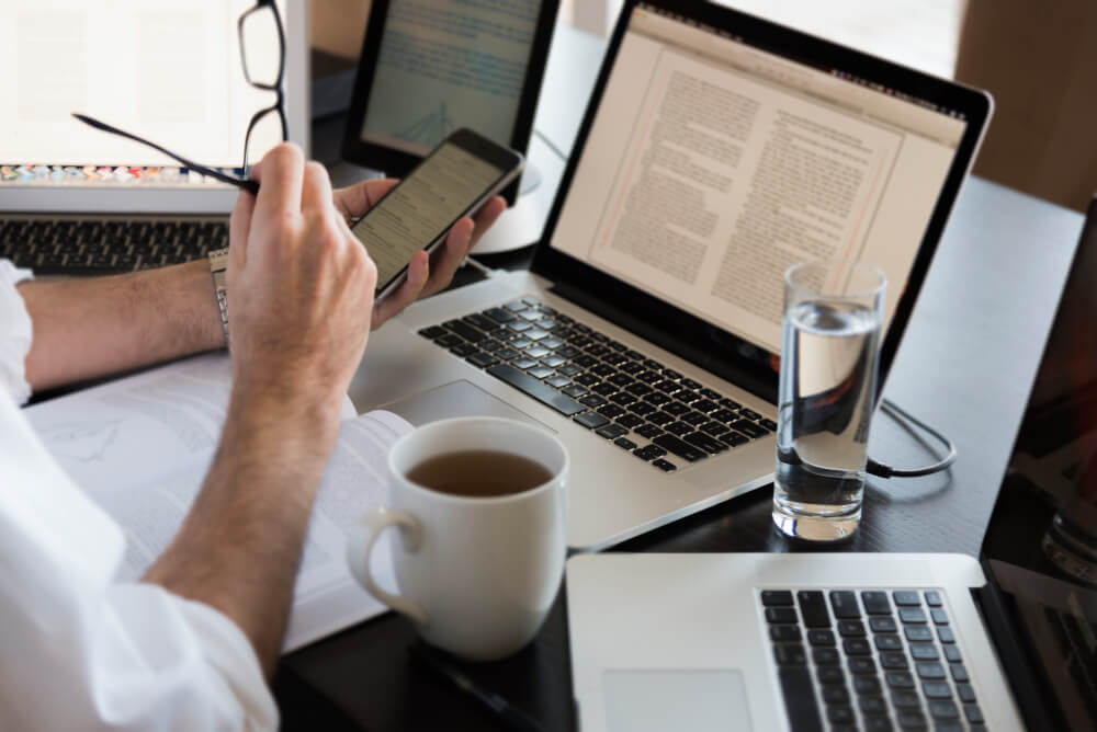 midsection-man-using-laptop-table